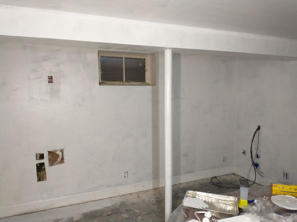 A basement room, recently covered in a thin layer of liquid white.