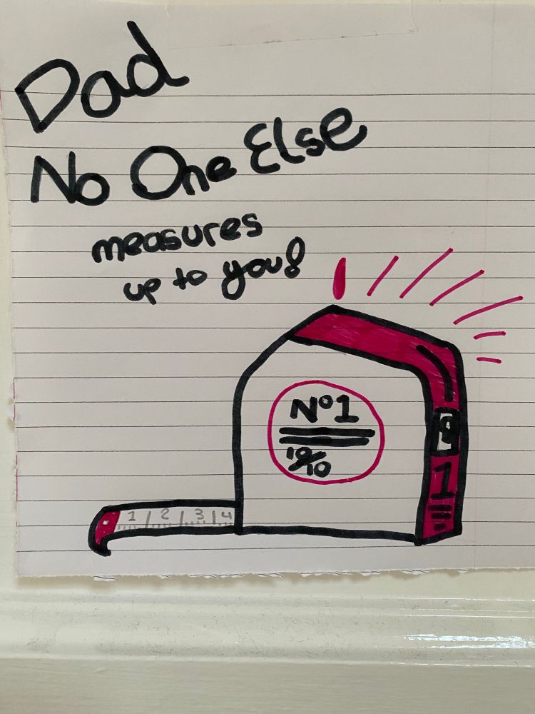 Drawing of a measuring tape with “Dad, no one measures up to you!” message from my daughter.