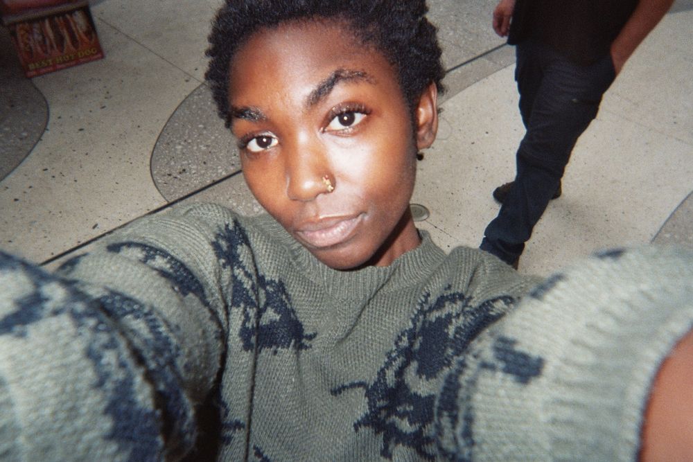 Aa teenager takes a selfie. The image shows the camera's perspective, so that the teenager is straight at us.