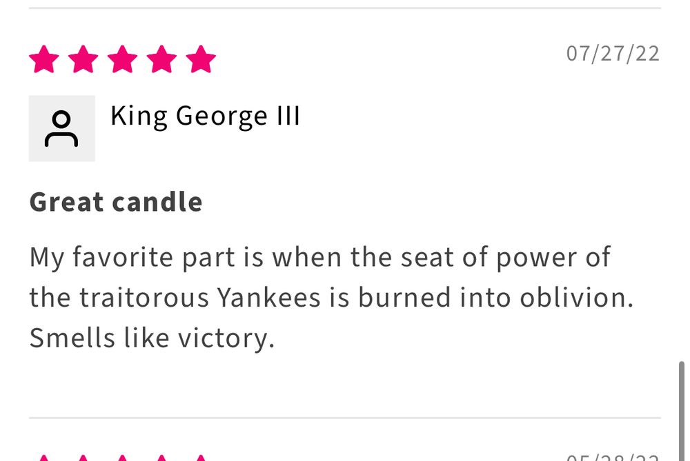 A five-star product review dated 07/27/22 from a user named “King George III.” The review title is “Great candle.” The review text reads: “My favorite part is when the seat of power of the traitorous Yankees is burned into oblivion. Smells like victory.” 