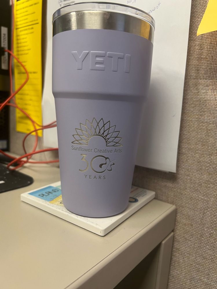 Lavender yeti mug with the logo for Sunflower Creative Arts’ 30th anniversary.