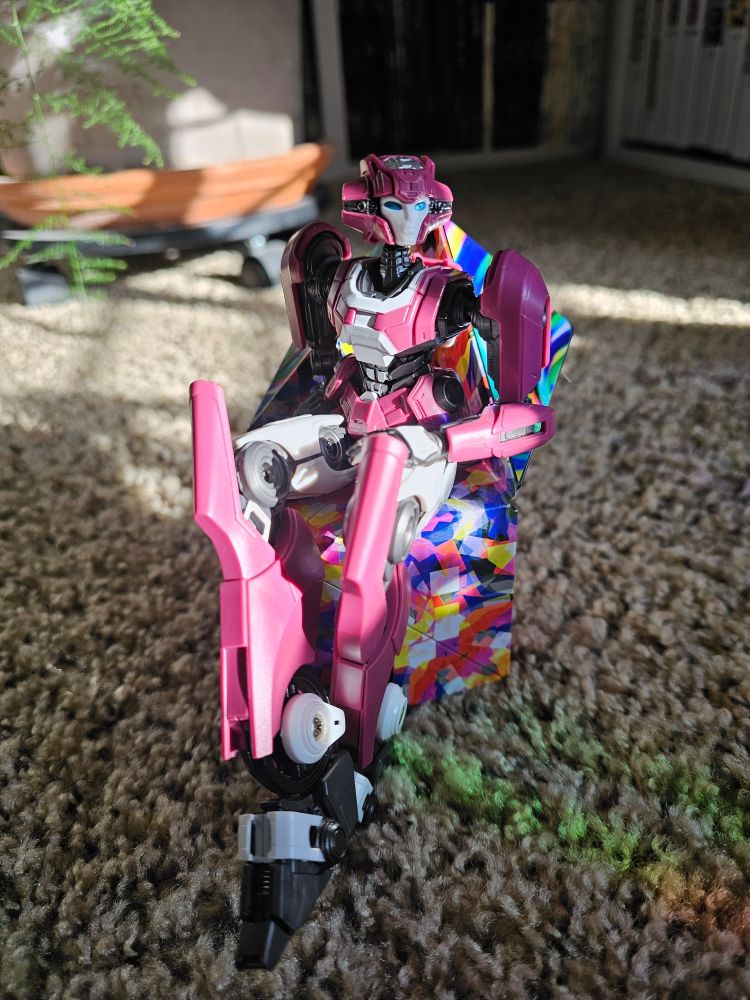Elita 1 sitting cross legged on a shashibo cube folded into a chair