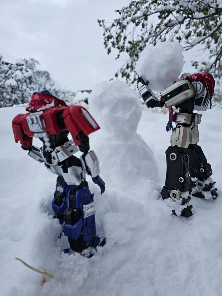 D16 lifting a ball of snow to stack on a partially assembled snowman