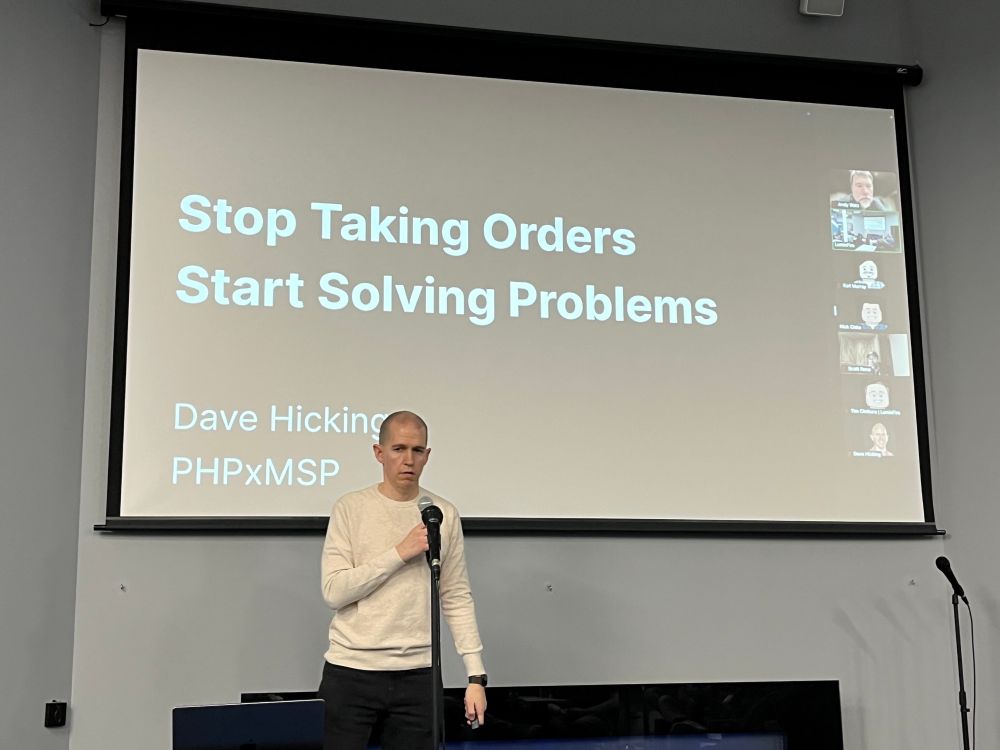 Dave Hicking in front of a slide with the title “Stop Taking Orders; Start Solving Problems”