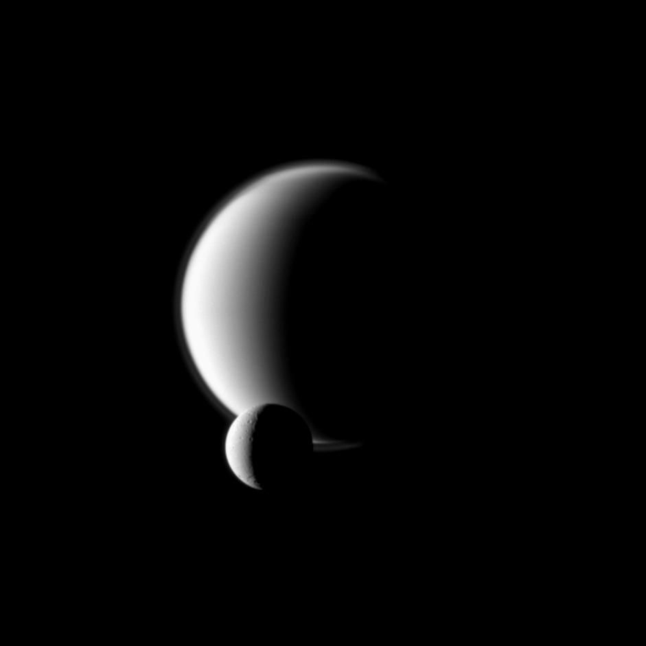 Titan, foregrounded by Enceladus.