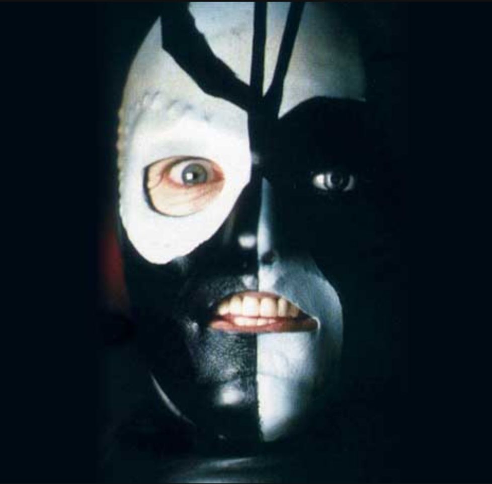 Sharaz Jek, from "The Caves of Androzani". One mad staring eye behind an abstract designed  black-and-white mask.