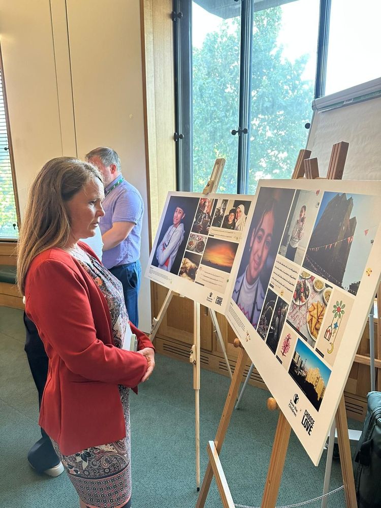 Vikki looking at a piece from Save the Children UK’s Parliament exhibition. 