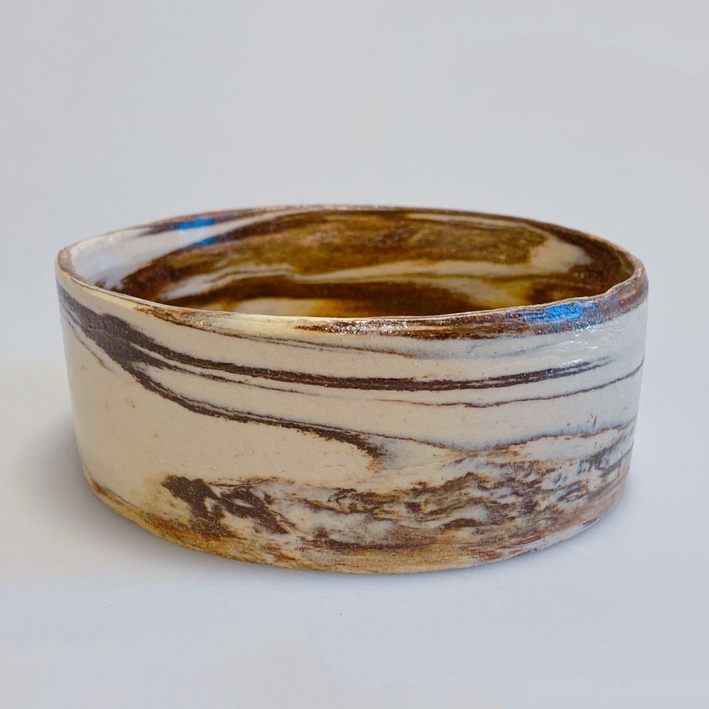 Marbled brown and white clay short cylindrical dish. This one looks like a slice of a birch tree