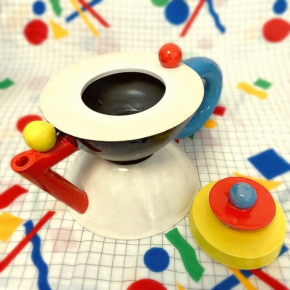 Three-quarter angle of the teapot with the lid taken off. The inside is black