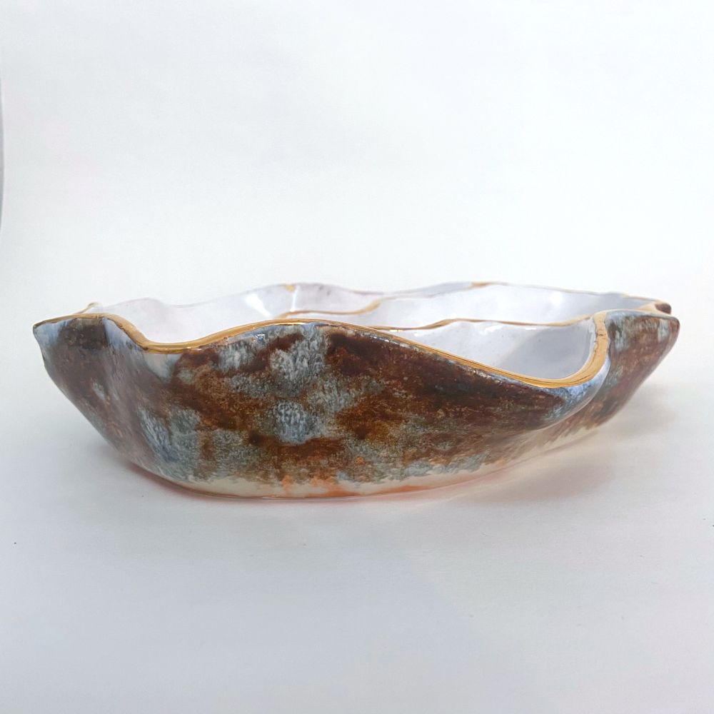 Side view of the bowl showing the black and gray glaze on the outside