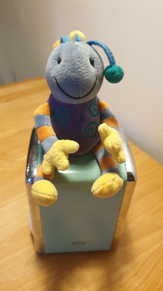 A soft toy sold as a millennium bug during the Y2K scare at the start of the 2000s. Very appealing with a nice smile and bobbly antennae. 