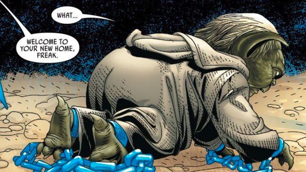 a comic panel from Star Wars 2015 issue 27 in which Yoda, on all fours, facing away from the camera, has been restrained by blue chains. he is told from someone off screen "welcome to your new home, freak." to which he replies: "what..."