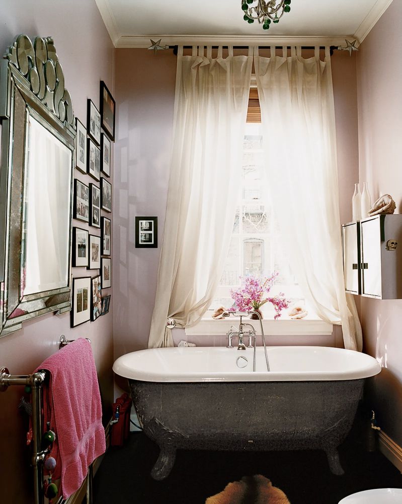 Bath tub, perter, venetian mirror, pink towel, skrim curtain, black frames, West Village, Stella Tennant, flowers, diffuse light, light fixture, lovely calming restful classic soak.