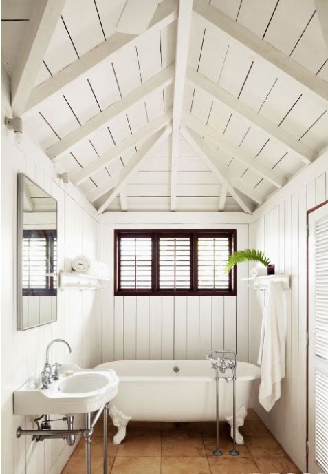White clawfoot bath tub St. Barth's window, slats, wood, fern, tile, closet, light, towel, sink, hardware, simple, beautiful, calm, clean, perfect.