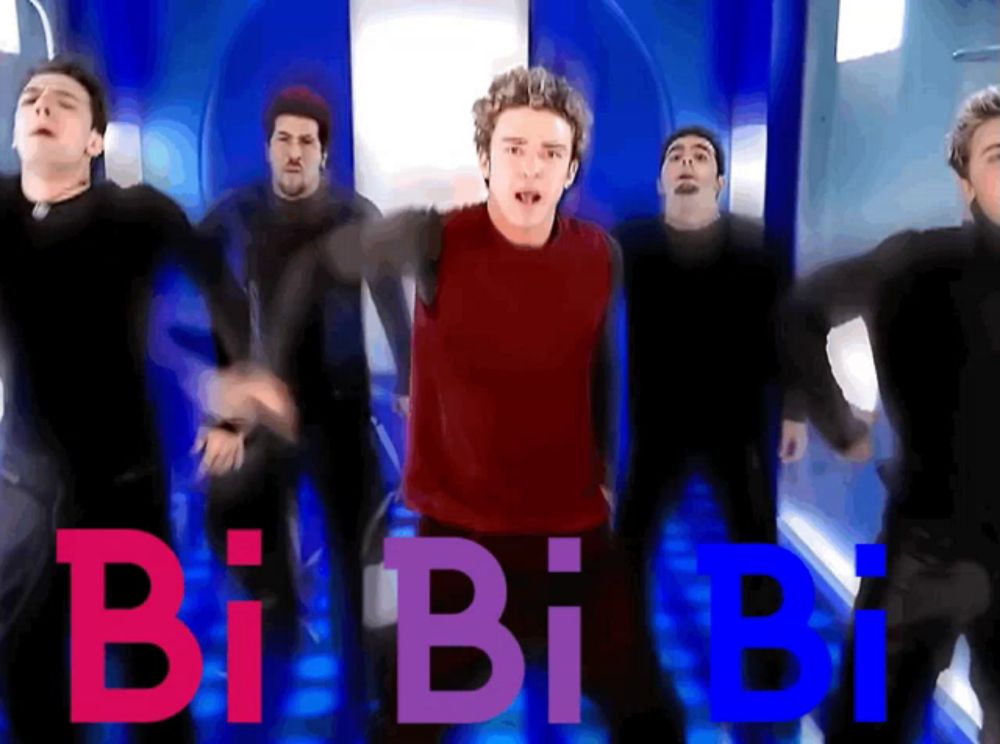 a group of men are dancing in front of a sign that says bi bi bi