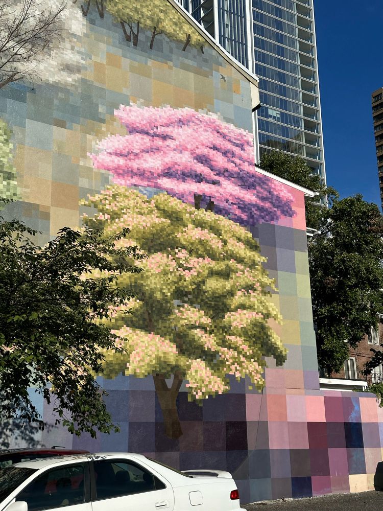 Mural of pixelated trees on the side of a building