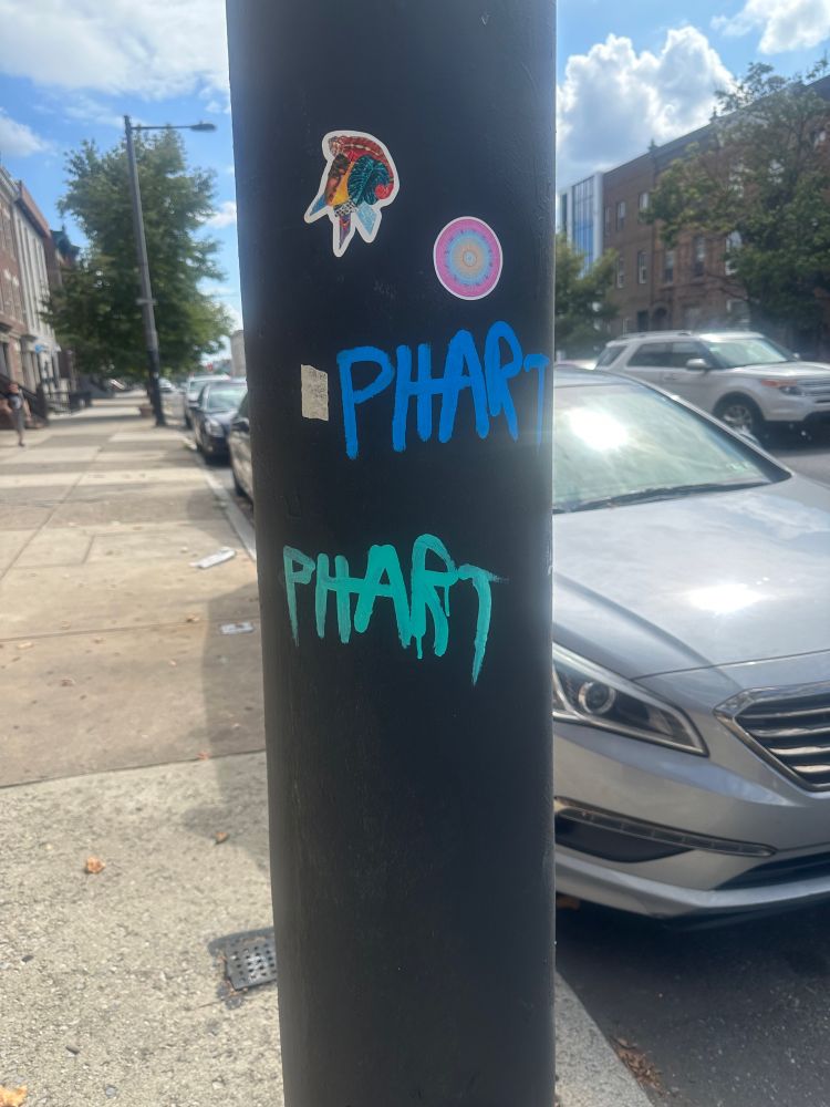 Graffiti of the word “phart” twice on a pole in Philadelphia