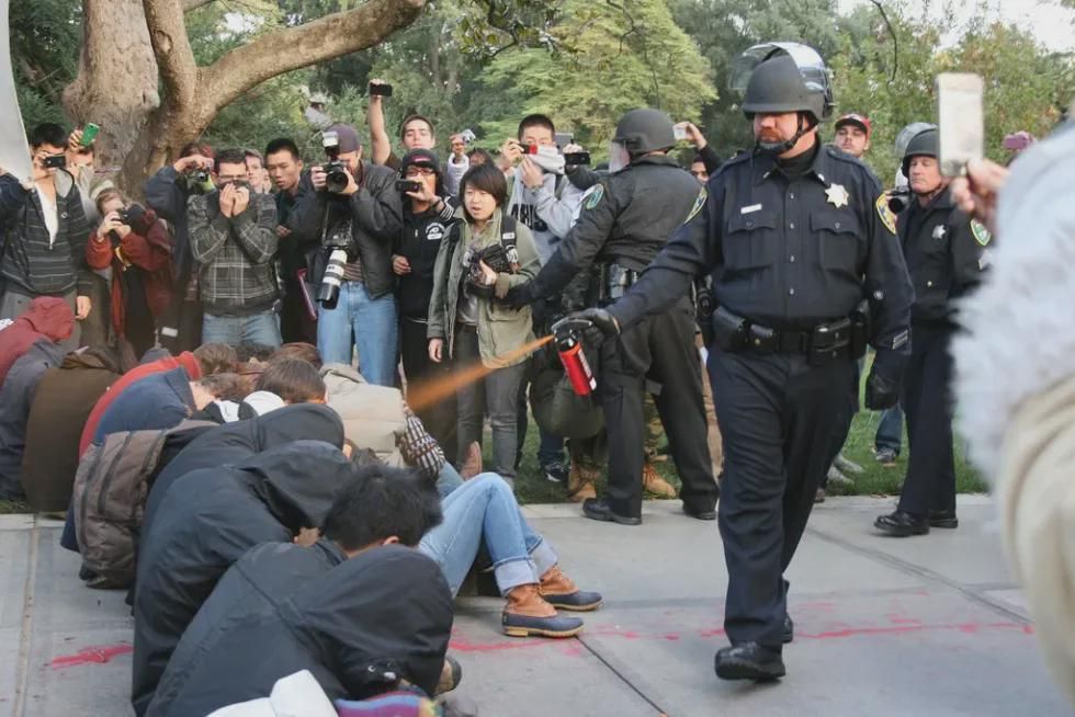 A picture of John Pike (the cop) spraying a group of seated protestors with pepper spray during the UC Davis incident back in 2011