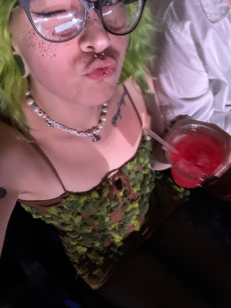 me posing with my dirty shirley dressed as the champagne problems piano at the eras tour indy. 