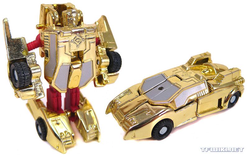 A photograph of Transformers: Armada Minicon Corona Sparkplug, shown in both robot and vehicle modes. It is a primarily chrome gold and deep red robot that transforms into a chrome gold "futuristic" car with silver windows.