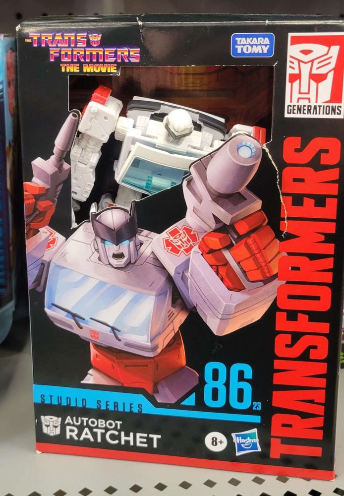 Amazon-exclusive "Galactic Odyssey Collection" Ratchet shoved into SS86 Ratchet's box, returned for a refund. The toy's gun is pegged into its hand, but it's unclear if the "shield" that makes up the top of the vehicle mode is present.