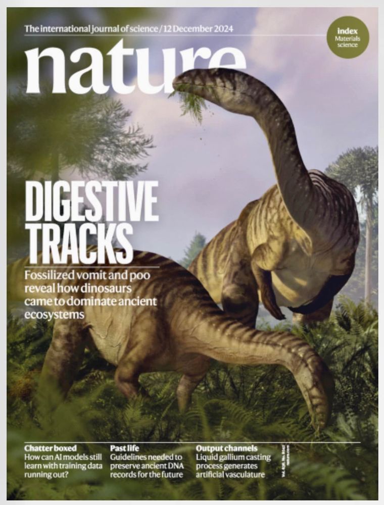 A magazine cover featuring two dinosaurs eating ferns.