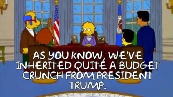 Scene from a 2000-era Simpsons episode involving a flash forward to the future. President Lisa Simpson is telling her cabinet, "As you know, we've inherited quite a budget crunch from President Trump."