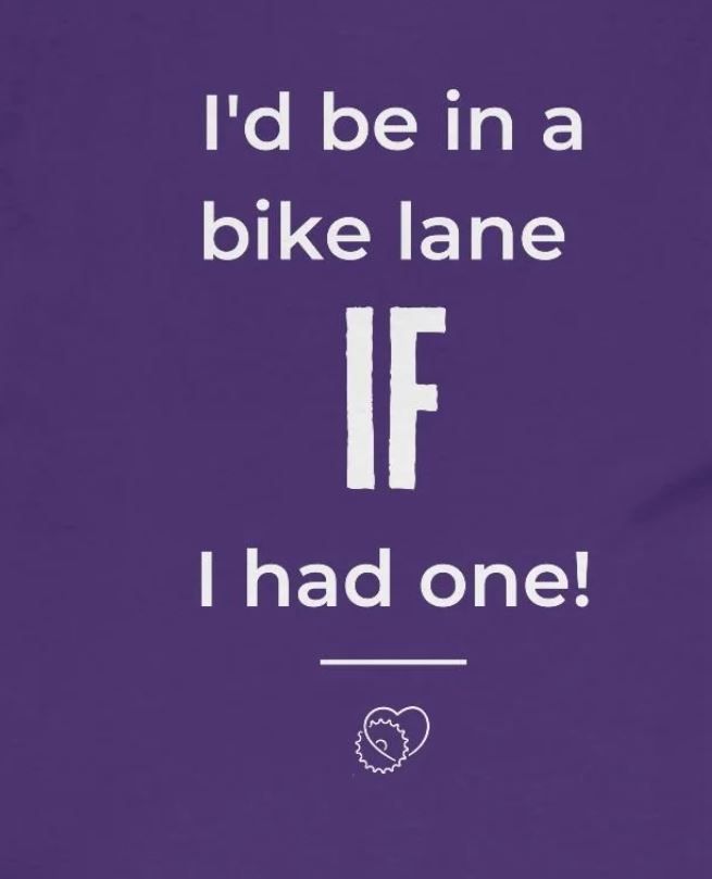 A purple image with white text that reads "I'd be in a bike lane IF I had one!" Below the text is a white horizontal line, followed by a small illustration of two gears forming a heart.