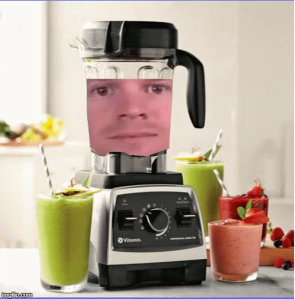 a vitamix blender with a man 's face in it