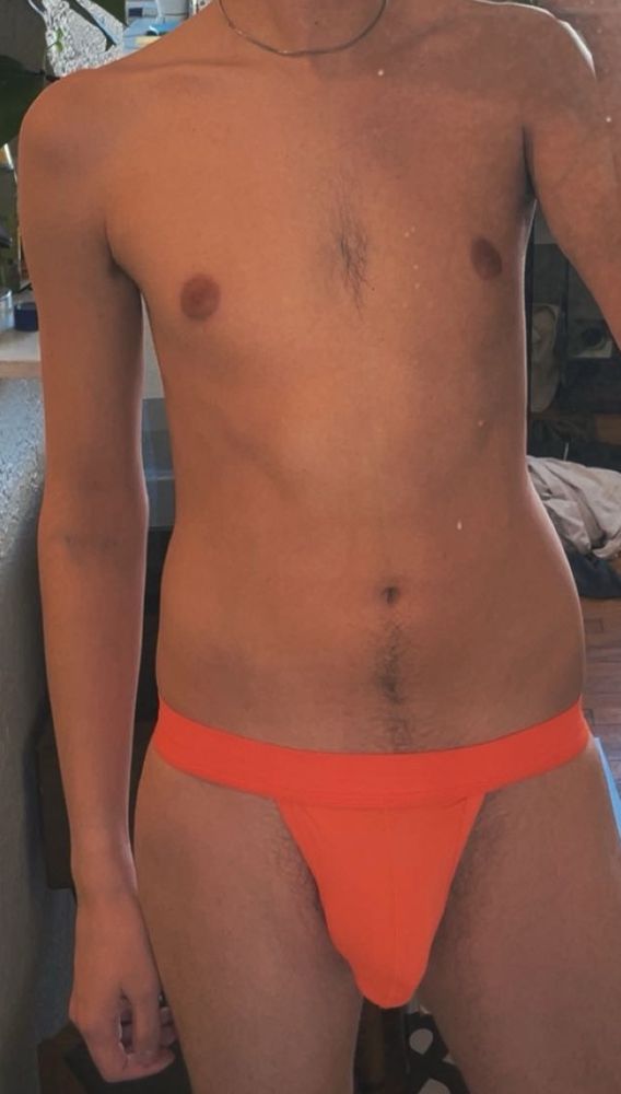 Mirror picture with a bright orange jockstrap on