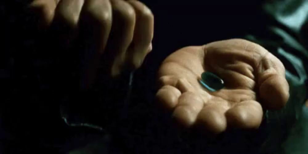 a man is holding a red pill and a blue pill in his hands