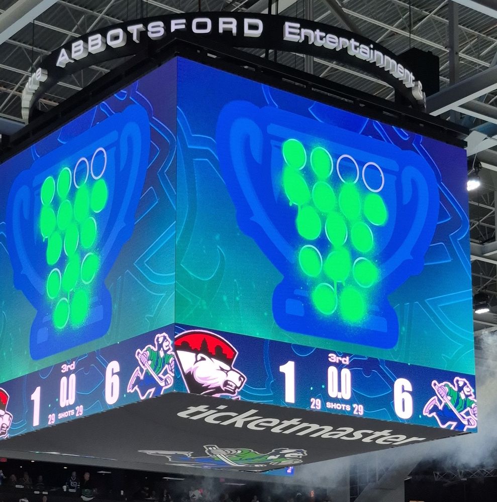 The jumbotron showing a trophy with green circles for the wins.

Score underneath 1-6 for the Abbotsford home team, 29 shots a piece.