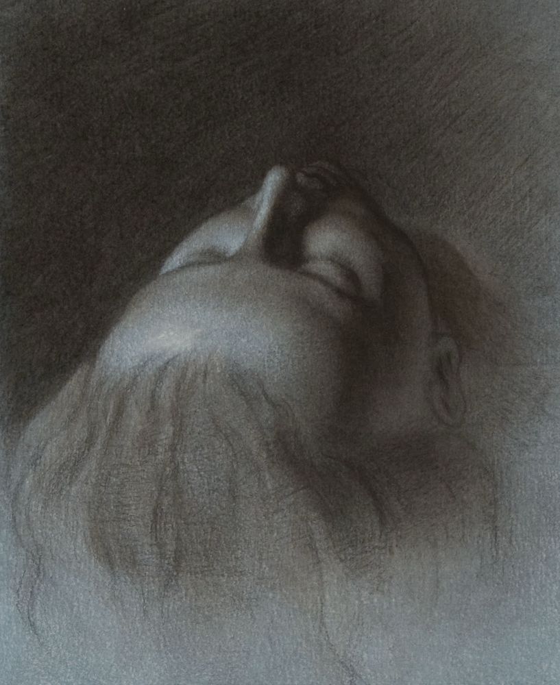Portrait drawing of woman lying down with eyes closed seen from above and behind her head in blue paper with charcoal white chalk highlights 