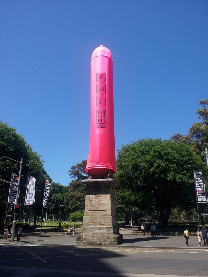 The same sewer vent with a large pink condom placed over it promoting HIV awareness