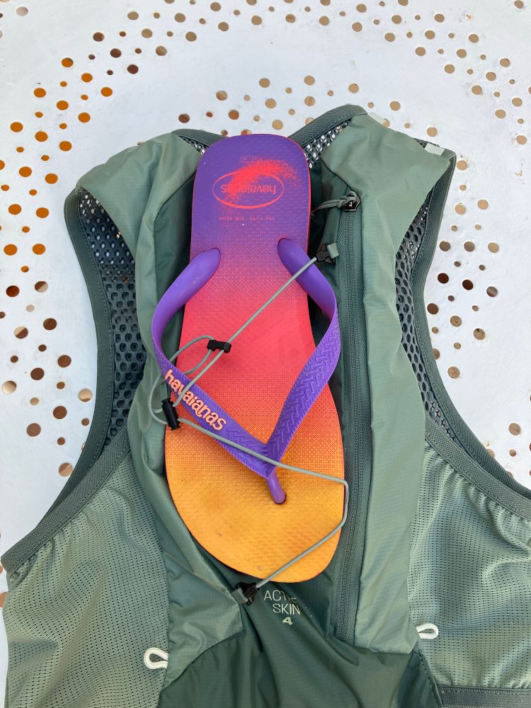 Running vest with a single flip flop attached 
