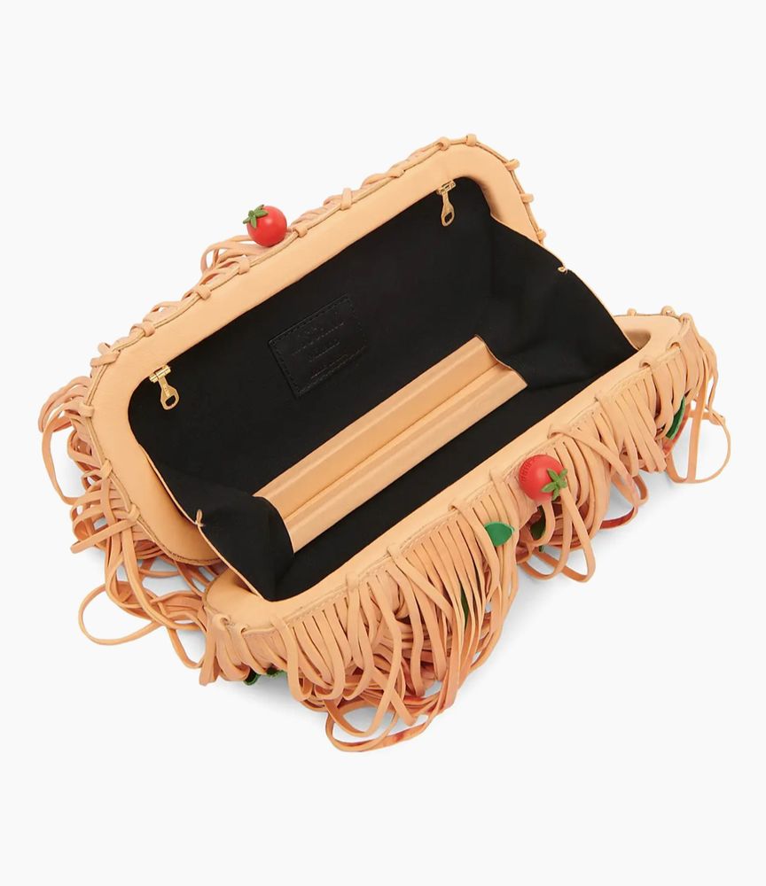 the same purse but open, revealing a black interior