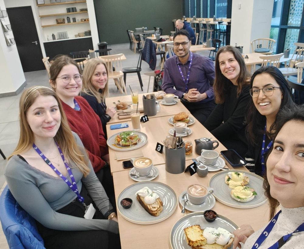 The Ali Lab members in a cafe, sitting around a table ready to eat brunch.