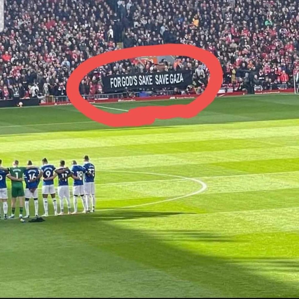 A group of Liverpool fans hold a banner at a match that says “For God’s sake save Gaza”