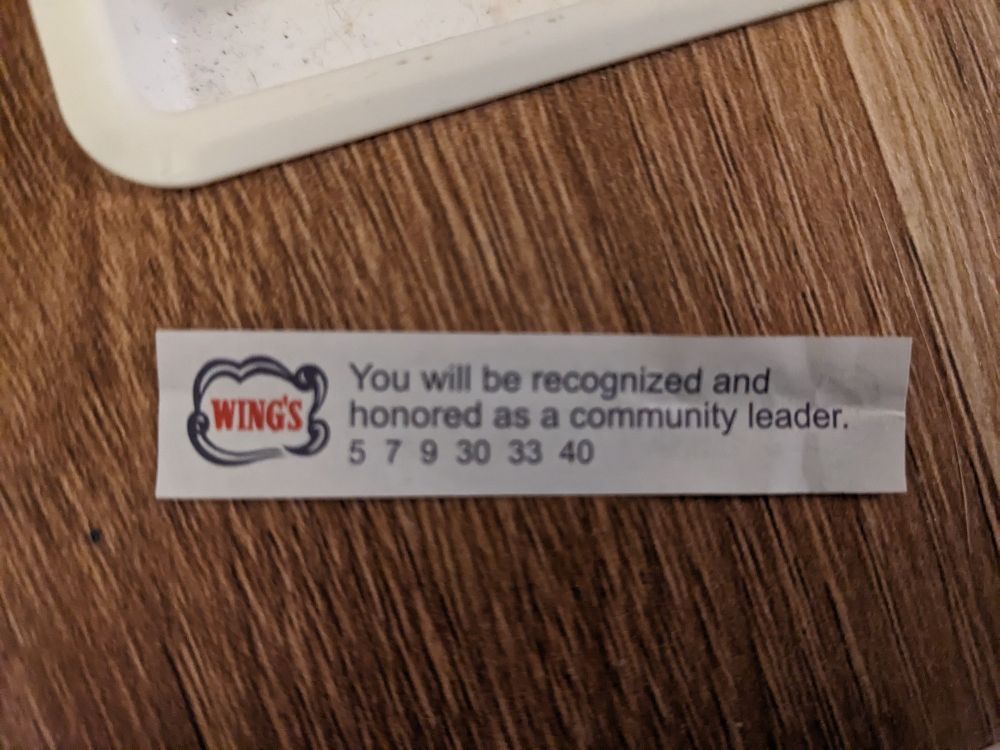 A fortune paper from a cookie, reading "you will be recognized and honored as a community leader." Along with the numbers 5 7 9 30 33 and 40.