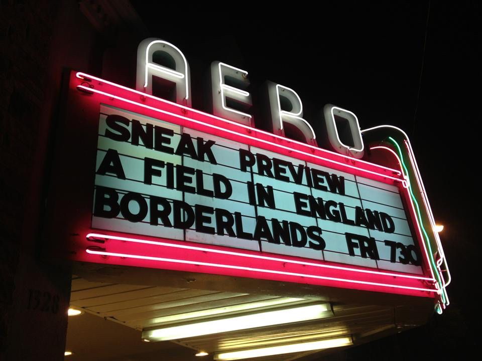 A neon cinema marqui for the Aero cinema that reads “sneak preview / A field in England / Borderlands / Fri 730”