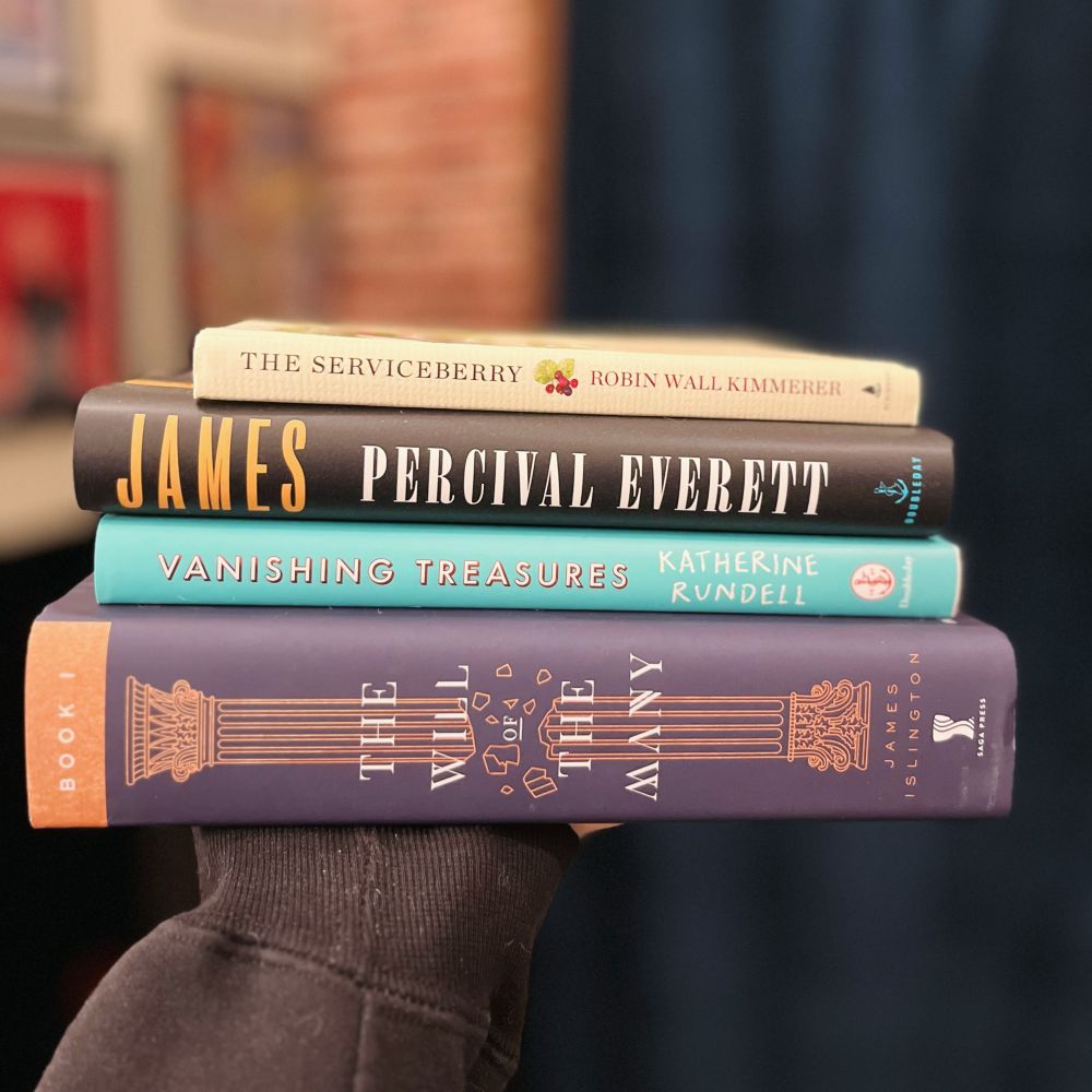 Stack of books containing the Will of the Many by James Islington, Vanishing Treasures by Katherine Rundell, James by Percival Everett and The Serviceberry by Robin Wall Kimmerer