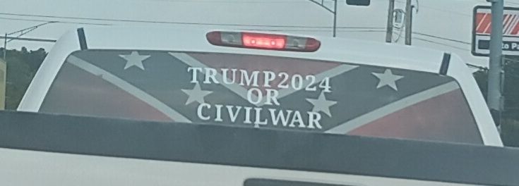 A decal on a pickup truck rear window from before the 2024 election calling for civil war if he doesn't win