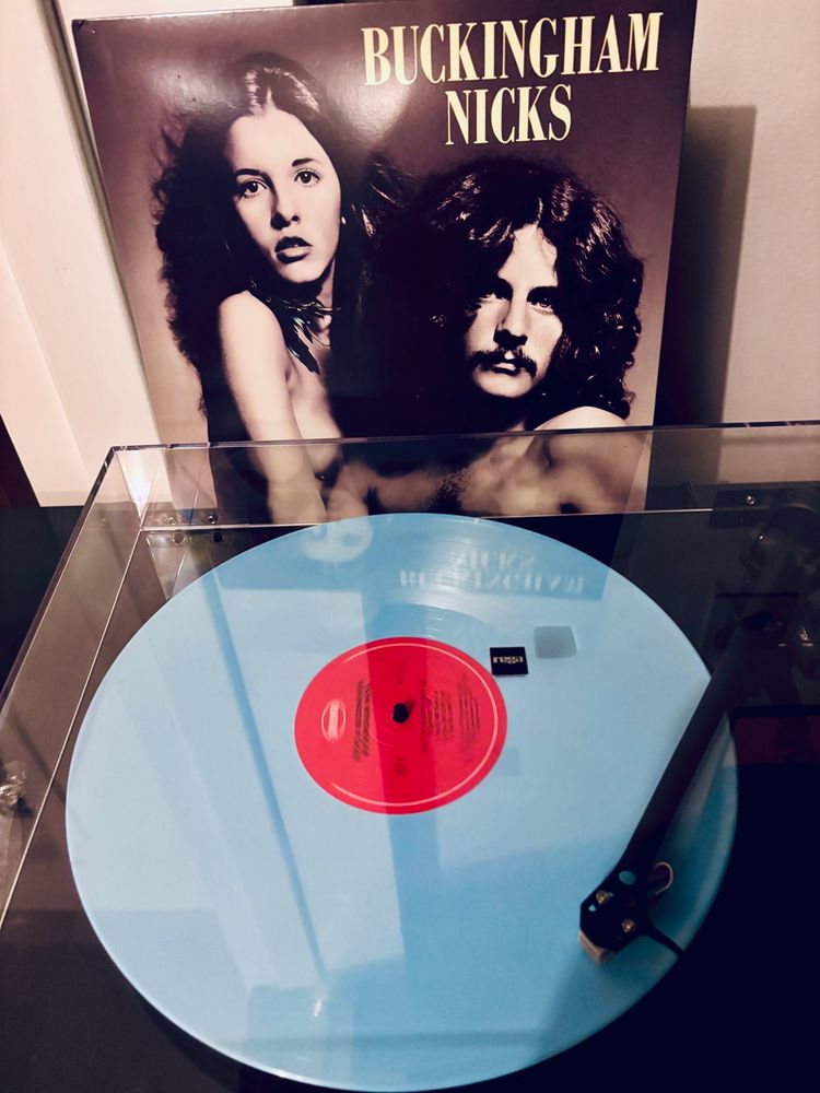 A robins egg blue vinyl record of Buckingham Nicks playing on a turntable