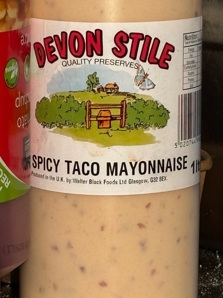 A plastic bottle of a beige flecked substance labeled Spicy Taco Mayonnaise