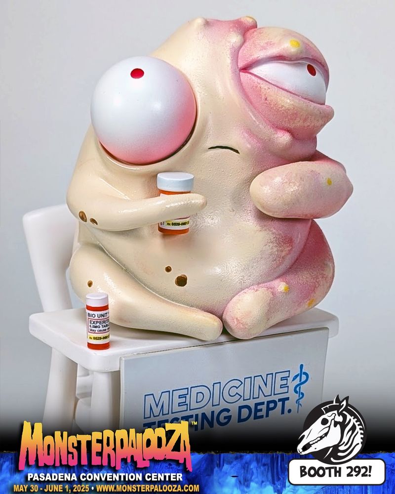 Photo of creature with bulging eyes, one side of it's body is swollen and gross, holding a pill bottle, sitting atop a desk that has a Medicine Testing Dept. Sign