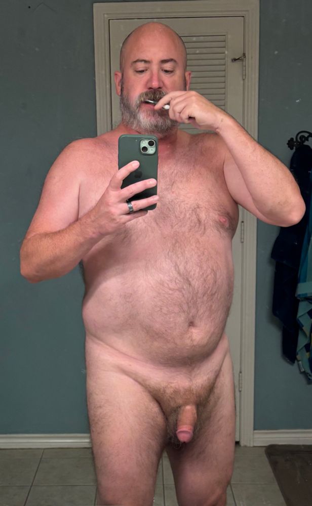 A naked man brushing his teeth. Yeah, weird thing to take a photo of.