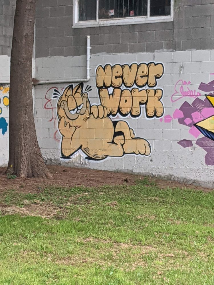 graffiti of Garfield the cat with the text "never work" in bubble letters
