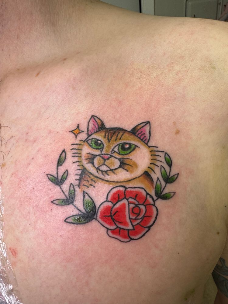 American traditional cat tattoo with a red rose