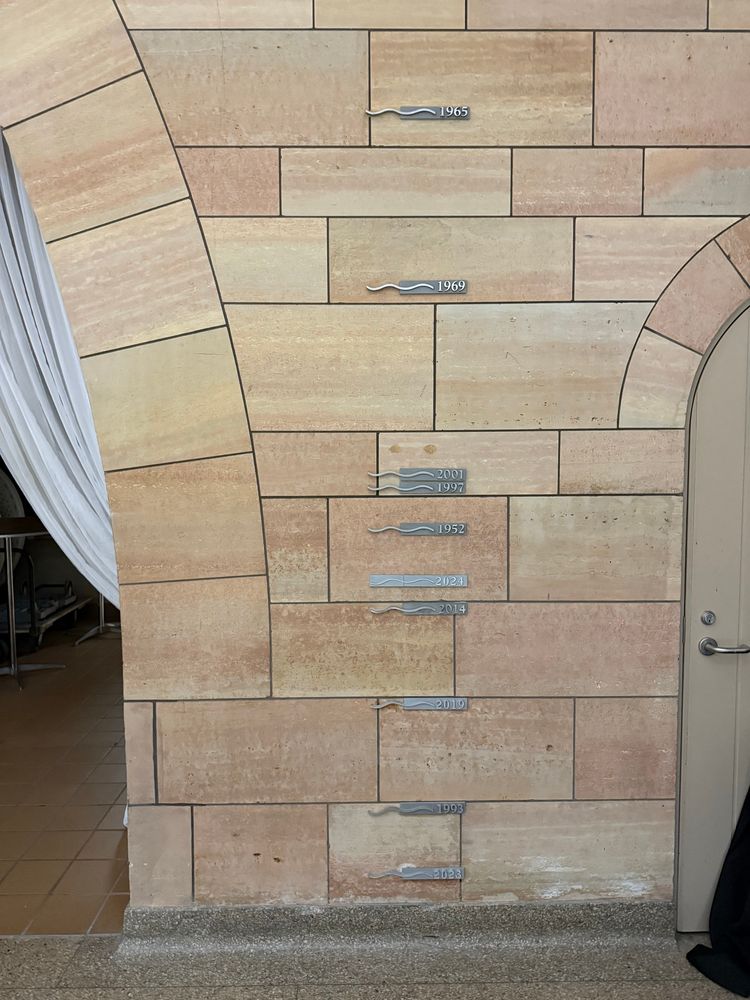 Flood lines on a wall. The lowest line is 2023, then 1993, then 2019, then 2014, then 2023, then 1952, then 1997, then 2001, then 1969 which was about as tall as a doorway, then the highest was 1965. 