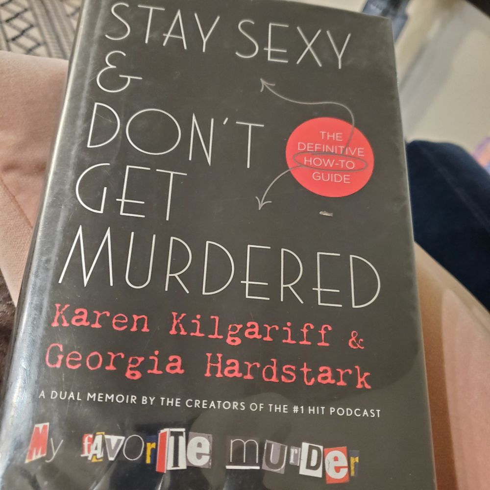 A copy of the book "Stay Sexy and Don't Get Murdered: The Definitive How-To Guide" by Karen Kilgariff and Georgia Hardstark. 